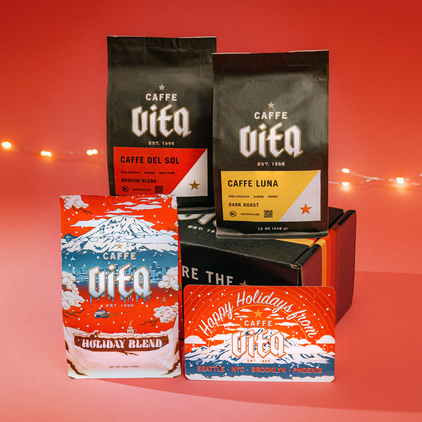 holiday, del sol, and luna blends on sunset box with postcard assembled over red background with tree lights.