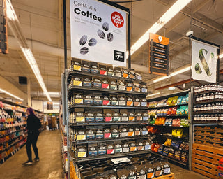Display of 12oz bags of various Vita coffees in grocery store