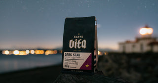 Dark Star 12oz bag on nighttime beach with lighthouse