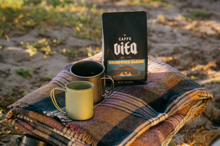 12oz bag of Campfire blend on blanket with cups in the woods. 
