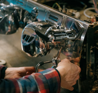 Hands fixing espresso machine
