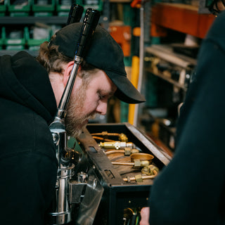 Caffe Vita service team member fixing an espresso machine.