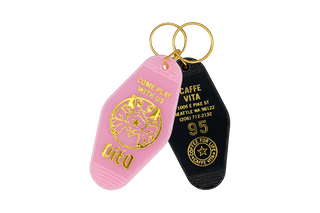 Motel style keychains, pink and black, with double Pulcinella, Come Play With Us, Capitol Hill address, 95, and Coffee For Life logo
